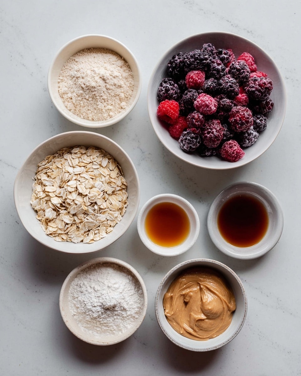 The image shows six white bowls on a white marbled surface. The top left bowl contains light beige flour with a fine texture. To its right is a bowl full of mixed frozen berries in dark red, black, and purple colors with a frosty texture. Below the flour bowl is a bowl of dry rolled oats with a pale tan color and a rough, flaky texture. In the center is a small bowl with white powder that looks soft and fine. On the bottom right side, there are two bowls: one has smooth light brown peanut butter and the other has dark amber liquid, likely syrup. All bowls are round and smooth, placed in a loose cluster. Photo taken with an iphone --ar 4:5 --v 7
