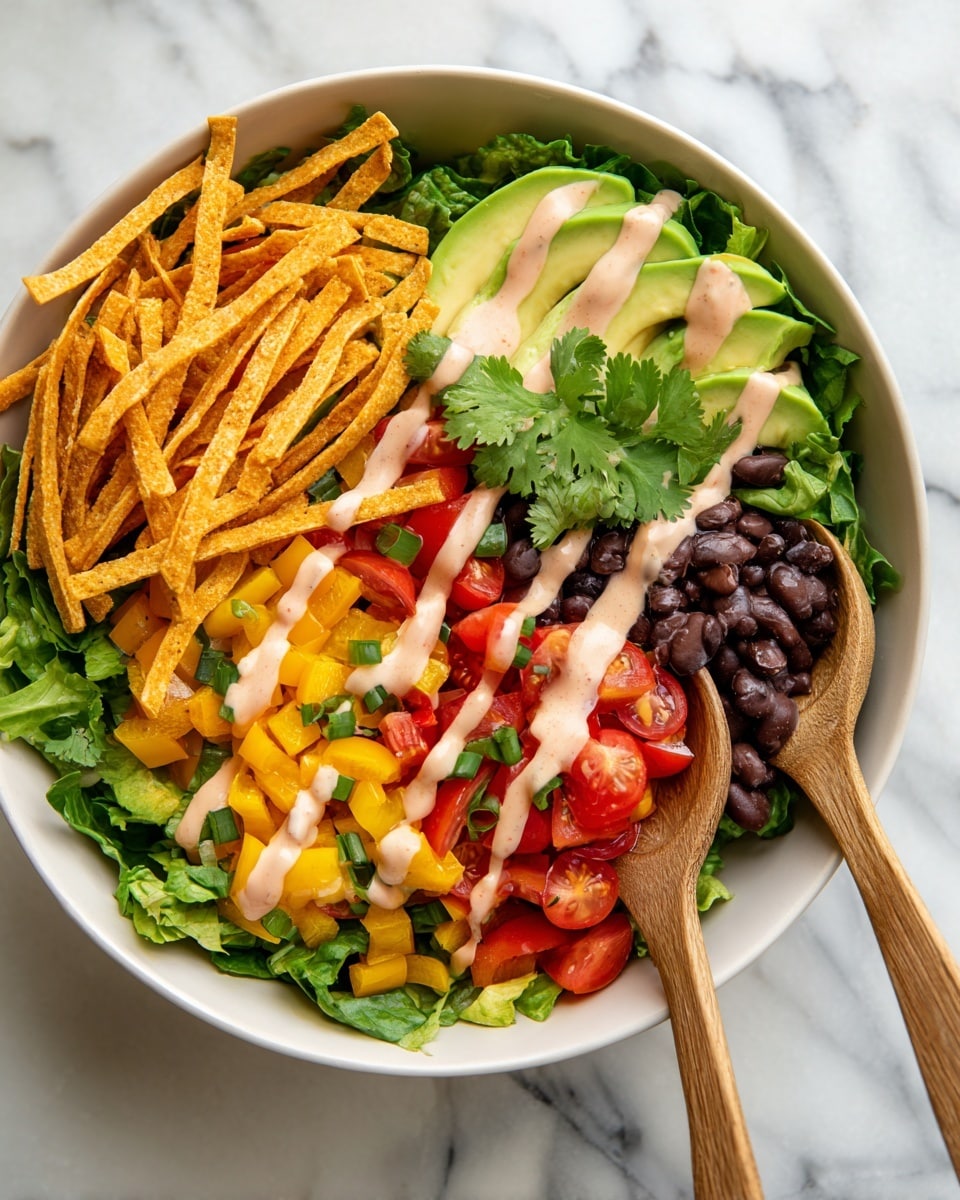 In the white bowl on a white marbled surface, there is a layered salad starting with a base of green lettuce leaves. On top, there are chopped yellow bell peppers mixed with small green pieces, halved red cherry tomatoes, and dark black beans. At the top right, three slices of light green avocado are placed with bright green cilantro leaves around. Orange crispy tortilla strips are spread over the top. A creamy light pink sauce is drizzled over the entire salad. Two wooden salad spoons rest in the bowl under the ingredients. Photo taken with an iphone --ar 4:5 --v 7