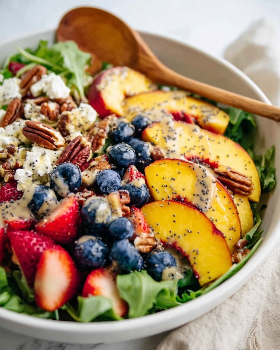 A white bowl holds a fresh salad with a base layer of bright green leafy greens. On top, there are thick slices of yellow and red peaches, whole blueberries with deep blue color, and bright red strawberries cut into halves or quarters. Small chunks of white cheese are scattered throughout, mixed with some brown pecan nuts. The salad is lightly drizzled with a creamy, light brown dressing with black poppy seeds sprinkled over it. The bowl sits on a white marbled surface with a wooden spoon resting inside. Photo taken with an iphone --ar 4:5 --v 7