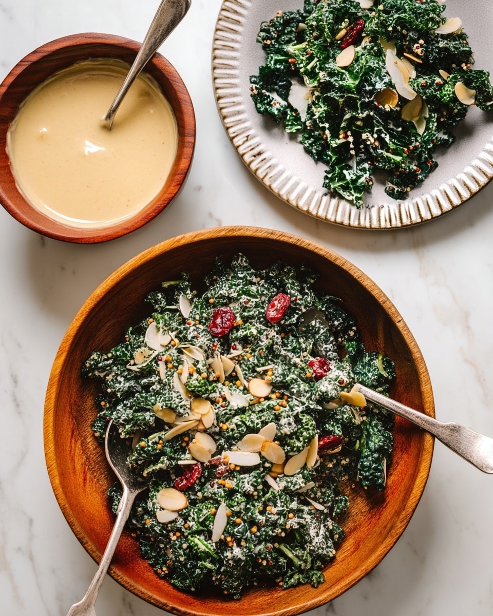 A wooden bowl filled with dark green kale leaves mixed with creamy white dressing, sprinkled with light beige almond slices, small red dried berries, and yellow mustard seeds; a silver fork and spoon rest inside the bowl. Above and to the right, a large white plate with ridged edges holds more kale salad with the same toppings. To the left, a small brown ceramic bowl contains a thick, light beige sauce with a spoon. At the bottom left, a wooden bowl holds cooked quinoa, showing white, red, and black grains. All items are on a white marbled surface. photo taken with an iphone --ar 4:5 --v 7
